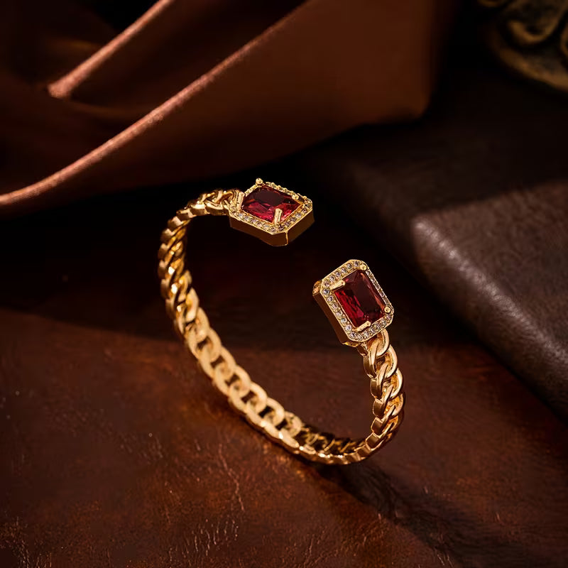 Elegant gold bracelet with a subtle ruby accent