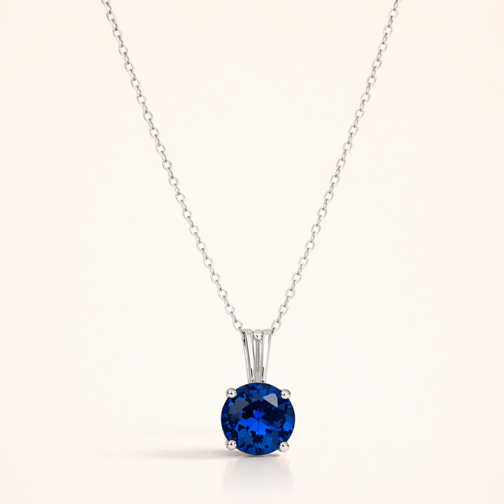 Elegant white gold necklace with round-cut sapphire