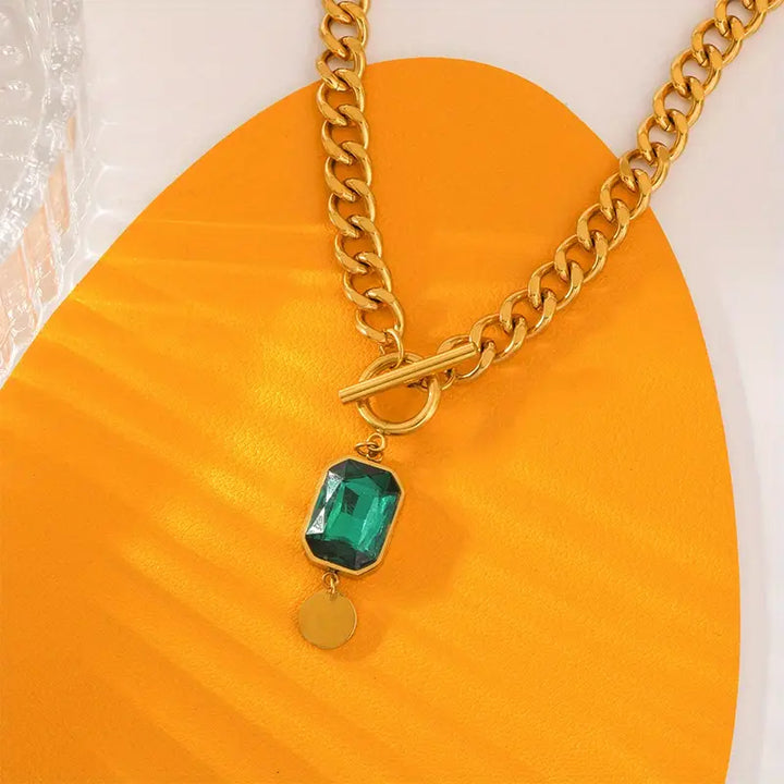 Elegant gold necklace with emerald pendant
