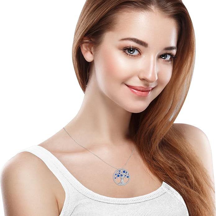 Elegant white gold pendant with sapphire and tree of life