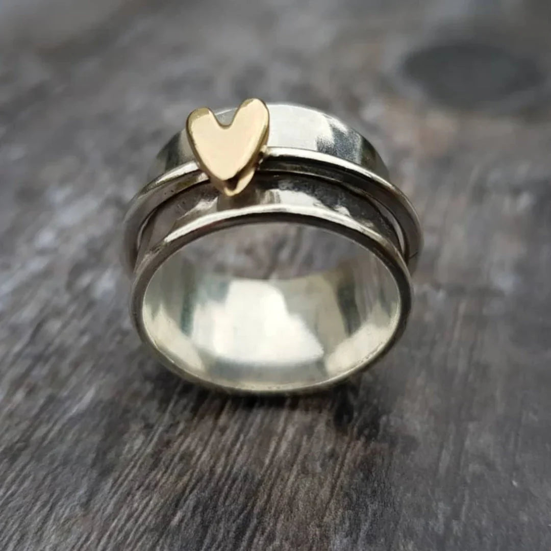Silver ring with little gold heart