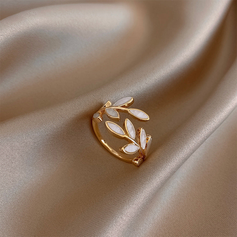 Simple silver ring with white opal leaf motif