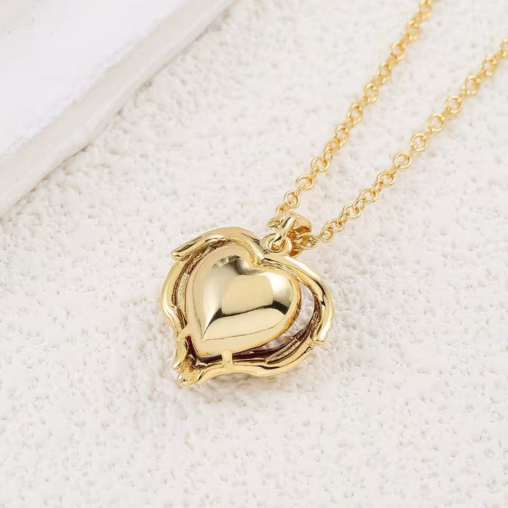 Soft Embrace gold necklace with ruby heart