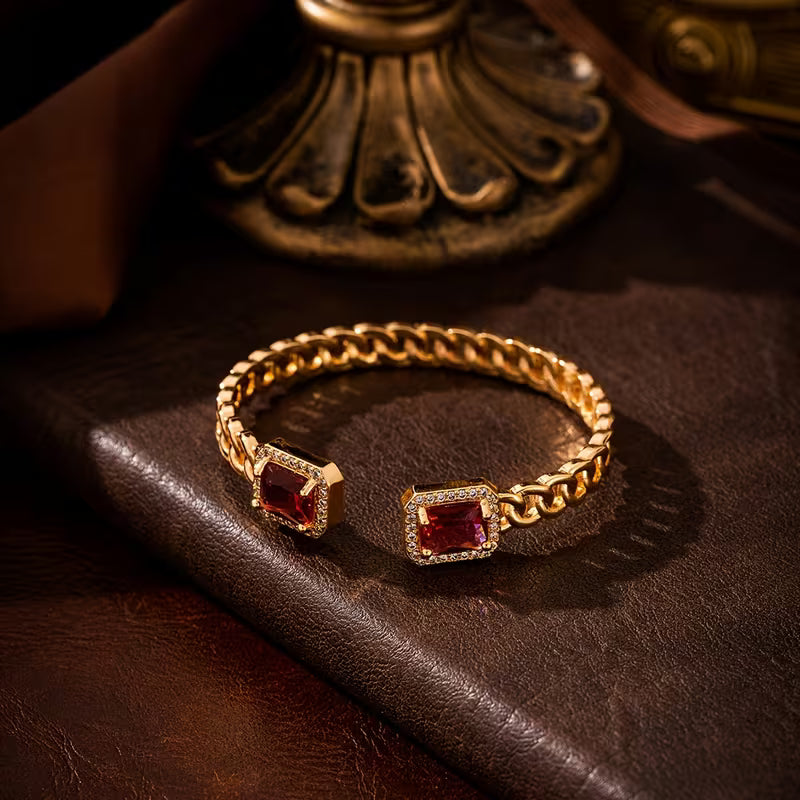 Elegant gold bracelet with a subtle ruby accent