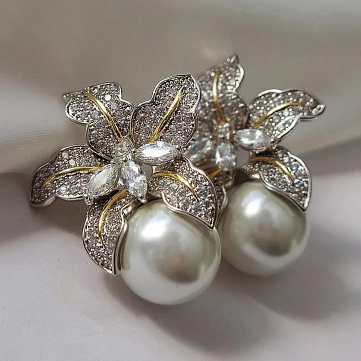 Elegant white gold pearl earrings with flower details